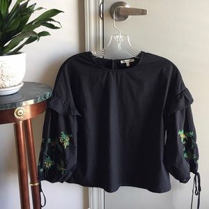 Black top with embroidered puffed sleeves
